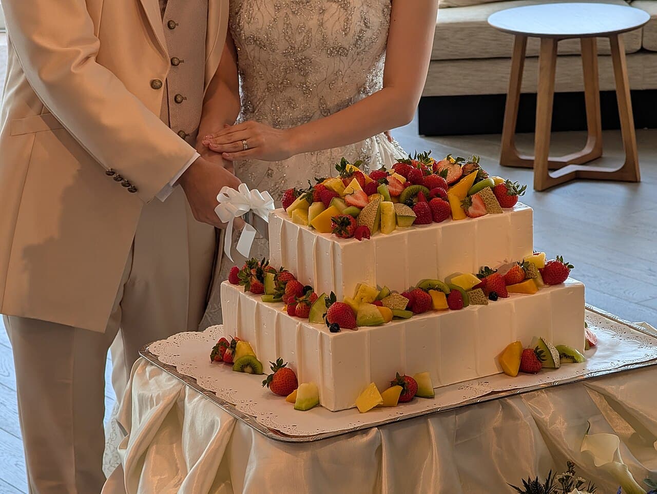 Couple cutting a tiered wedding cake