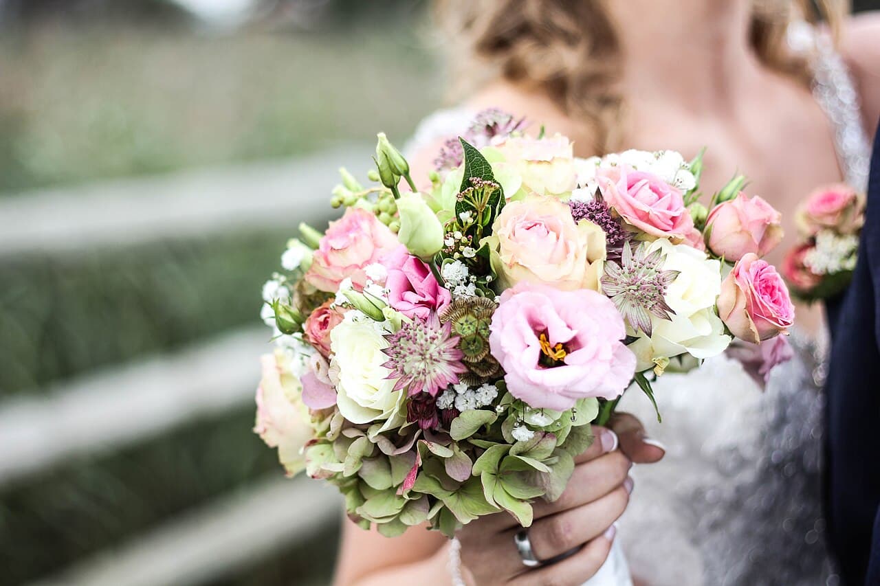 Bride holding a bouquet of pink and white flowers