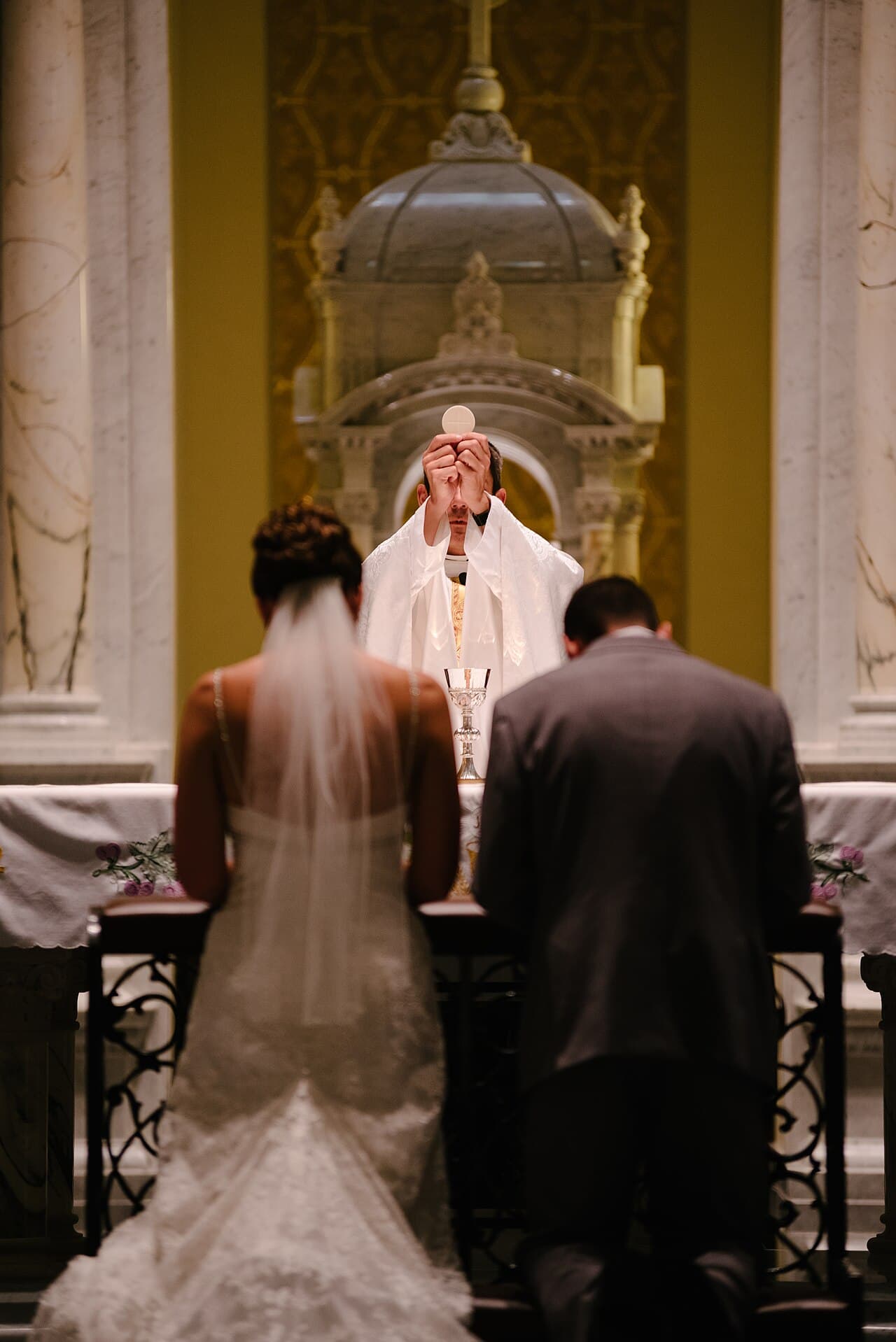 Couple standing before an officiant during a ceremony