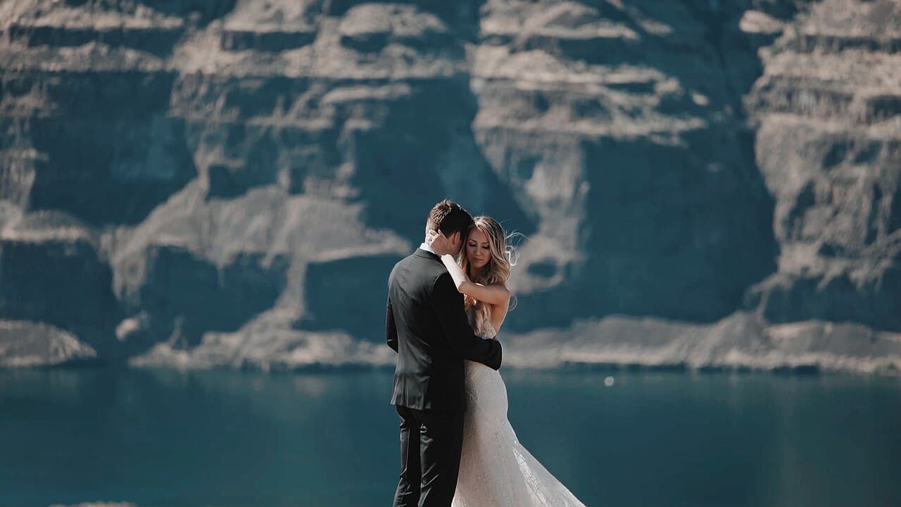Couple embracing on a cliff overlooking water