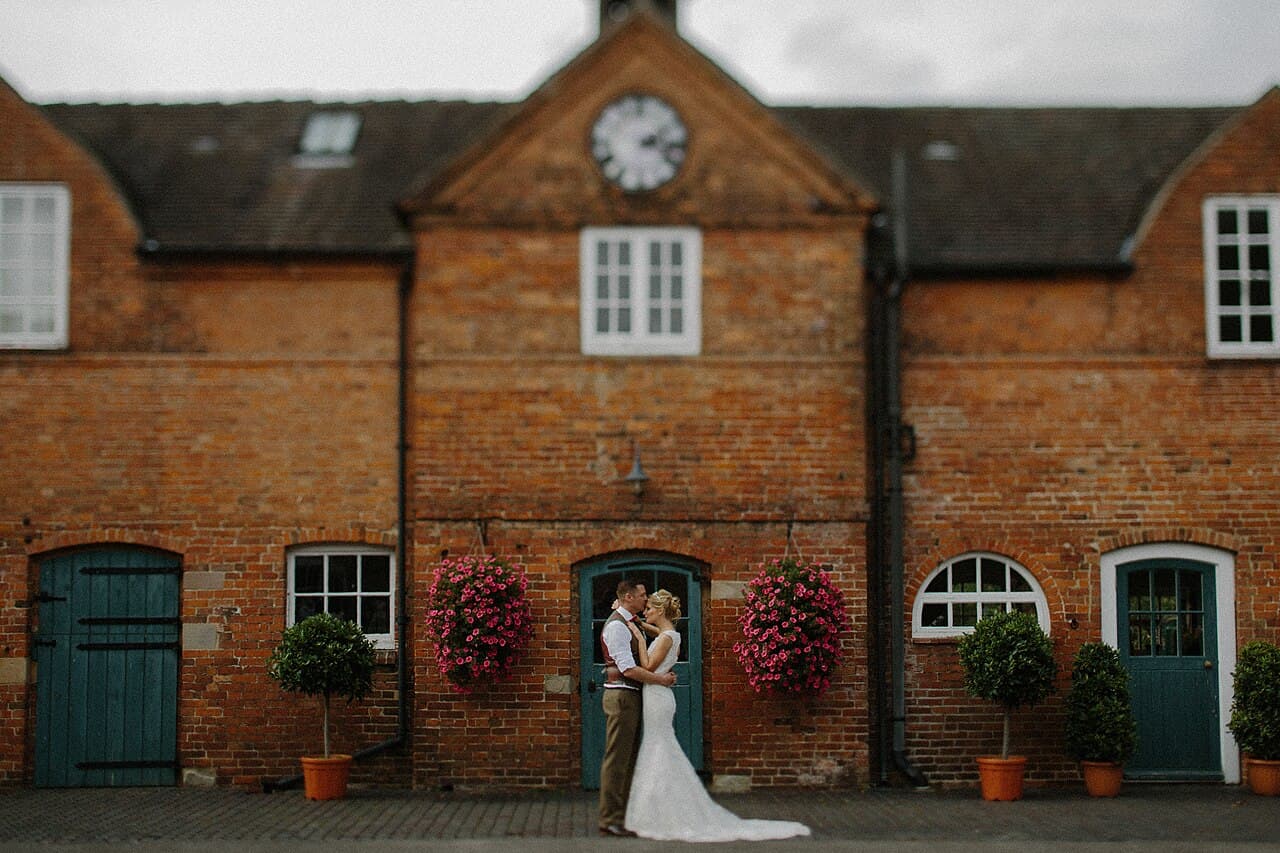 Couple standing outside a brick venue building