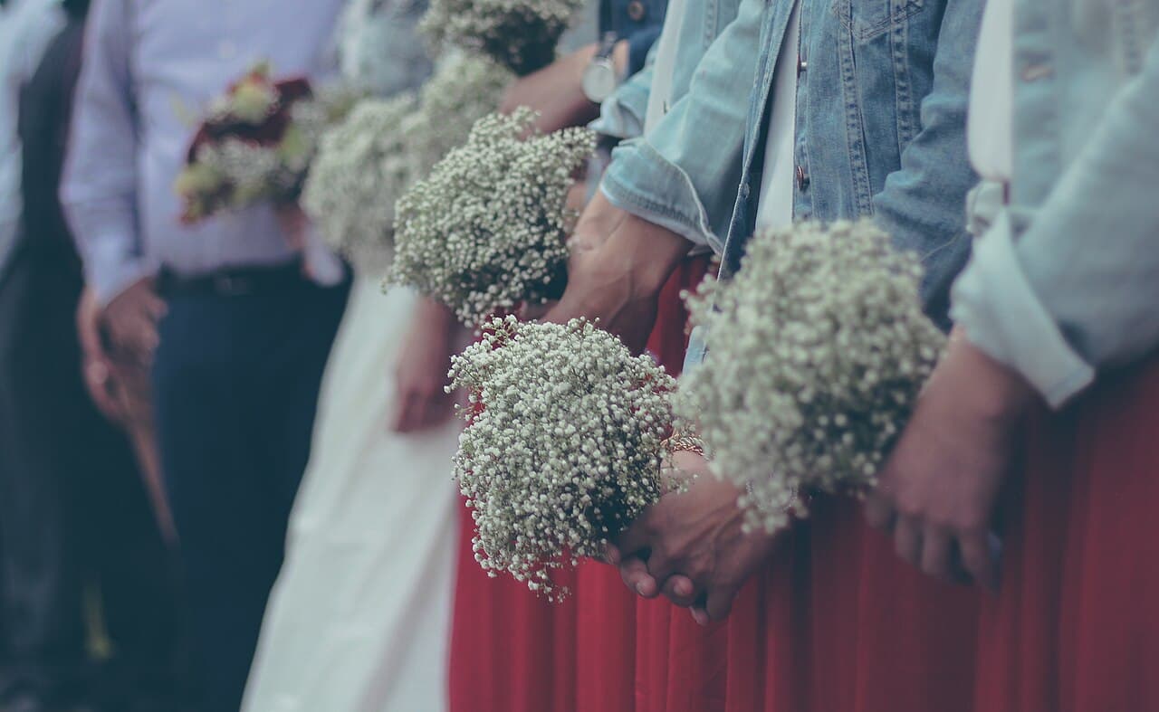 Wedding guests holding baby's breath bouquets
