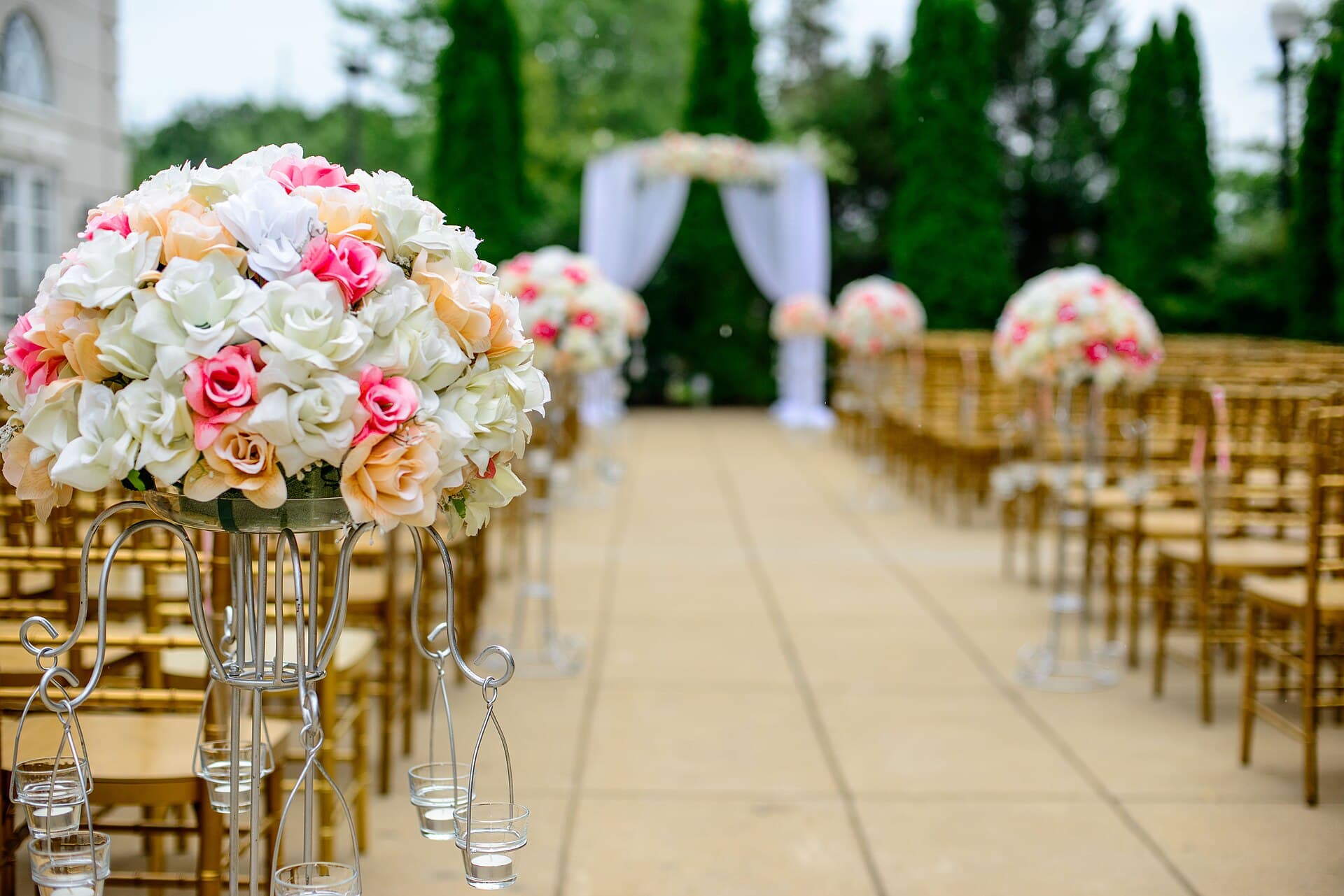 Wedding ceremony aisle lined with chairs and flowers